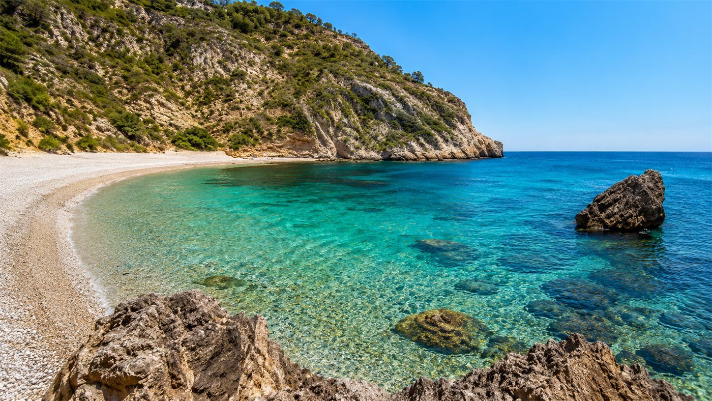 Crystal-clear turquoise water at Cala Granadella in Jávea, Valencia, ideal for SUP excursions